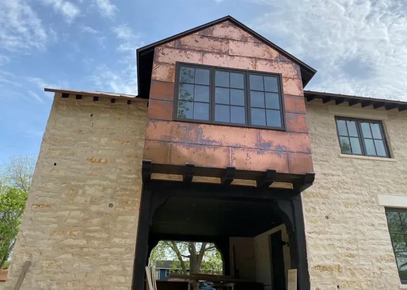 Copper metal panel facade on a stone building for Roof Repair in East Foothills